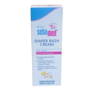 Front view of a white and light blue vertical box of Baby Sebamed Diaper Rash Cream. The packaging features a "clinically tested pH 5.5" logo, text highlighting "With Panthenol" in a pink bar, key product benefits listed in bullet points, and a small illustration of a crawling baby wearing a diaper.