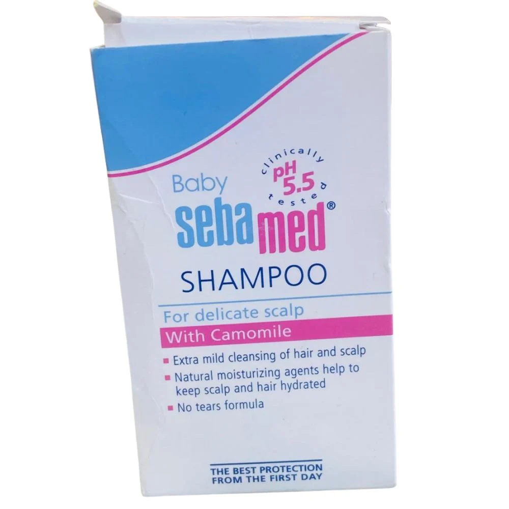 Sebamed Baby Shampoo packaging box, featuring the pH 5.5 clinically tested seal and highlighting its mild no-tears formula with Camomile for a delicate scalp.