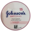 Top-down view of a round pink container of Johnson's Soft Cream for face and body, showing the product title in English and Arabic text for all skin types.