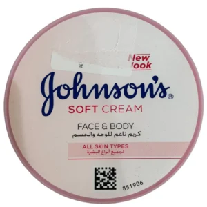 Top-down view of a round pink container of Johnson's Soft Cream for face and body, showing the product title in English and Arabic text for all skin types.