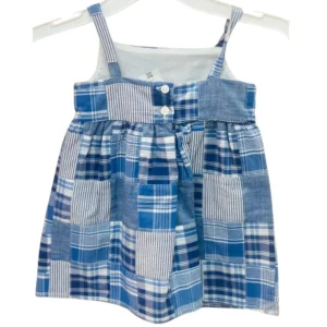 A sleeveless girls' dress featuring a blue and white patchwork plaid design with spaghetti straps and front button details.